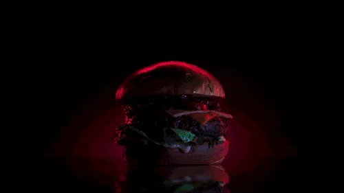 Animatie Burgerbar Unleash Your Lust: burger in rood licht tegen een zwarte achtergrond